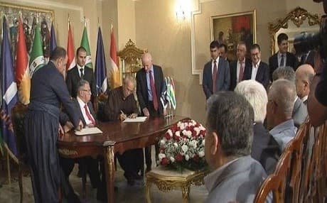 PUK and Gorran officials sign the historic agreement in Sulaimani on Tuesday, with PUK leader Jalal Talabani seated in between. Rudaw photo.