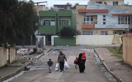 A family flees its home in an eastern Mosul neighborhood due to war in a Rudaw file photo.