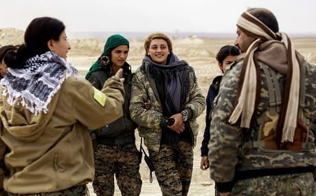 Female Arab fighters among the Syrian Democratic Forces, made up of US-backed Kurdish and Arab fighters, stand together near the village of al-Torshan, 20 km on the outskirts of Raqa last Monday. Photo: AFP/Delil Souleiman.