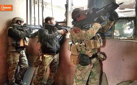 Soldiers of the Iraqi army take up position at a building in the troubled Bab al-Toub neighborhood in west Mosul.