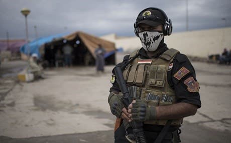 A member of the Iraqi counter-terrorism service forces at a processing center for displaced citizens in western Mosul. Photo: AFP/Christophe Simon