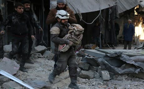 Rescue workers carry a victim of shelling in Deir Ezzor. AFP file photo
