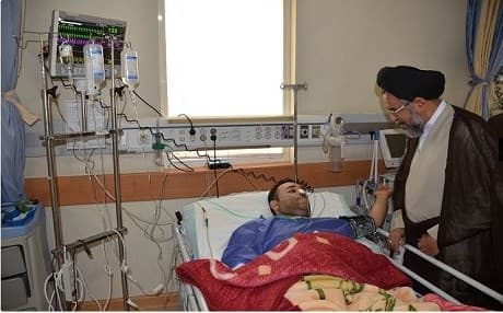 Iran’s minister of intelligence Mahmoud Alavi visits a man in a hospital in Iran who was injured in the ISIS-claimed twin attacks in Tehran on June 7, 2017. Photo: Iran's ministey of intelligence