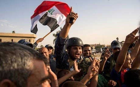 Members of Iraq's federal police force wave Iraq's national flag as they celebrate in the Old City of Mosul on July 9, 2017 after recapturing the city. Photo: AFP /Fadel Senna