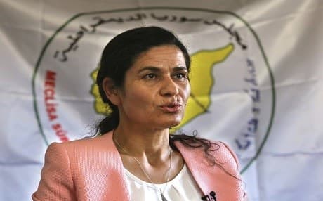 Ilham Ahmed, the co-president of the Syrian Democratic Council, the political wing of the Kurdish-led forces backed by the US in Raqqa, speaks during an interview with the Associated Press, in Kobani town, north Syria, Tuesday, July 25, 2017. Ahmed says the governing and securing of the Arab-majority city after the expulsion of IS militants will be a model for other areas in Syria and the future of governing the war-torn country. She says the Kurdish-led effort needs US political and financial support. (AP Photo/Hussein Malla)