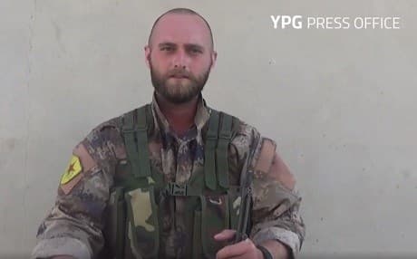 David Taylor, nom de guerre Zafer Qerecox, is shown in military fatigues bearing a YPG patch. Photo: YPG Press