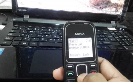 This representational photo shows a person receiving a pin code on a mobile phone that could be used to transfer money.