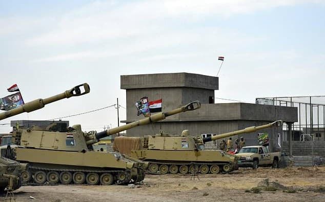 Iraqi army vehicles in a position formerly held by the Peshmerga in Tuz Khurmatu on Friday. Photo: AFP