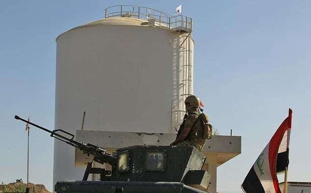 A member of the Iraqi forces stands guard at Bai Hassan oil field near Kirkuk on Thursday. Photo: Ahmad al-Rubaye/AFP