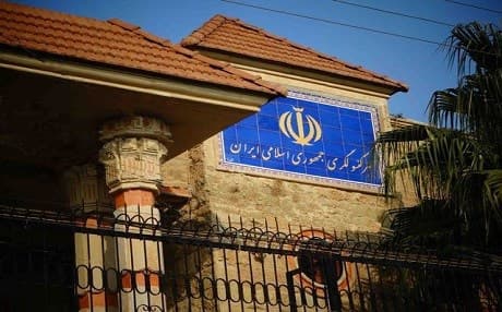 A video shared on Kurdish social media shows a young man climbing over the wall of the Iranian consulate and taking down the Iranian flag to cheers by protesters.