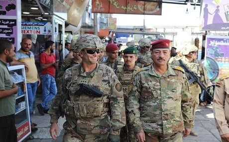 In this Oct. 4, 2017 photo released by the U.S. Army, Lt. Gen. Paul Funk, left, commanding general of Combined Joint Task Force-Operation Inherent Resolve, and Iraqi Maj. Gen. Najm Abdullah al-Jibouri, right, commander of the Nineveh Liberation Operation, walk through a busy market near the University of Mosul. Photo: (Spc. Avery Howard, U.S. Army via AP)