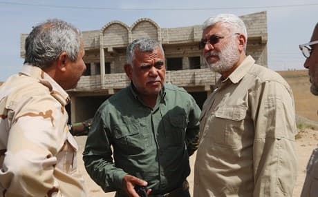Abu Mahdi al-Muhandis, on the right, with Hadi al-Amiri, centre. File photo: AP