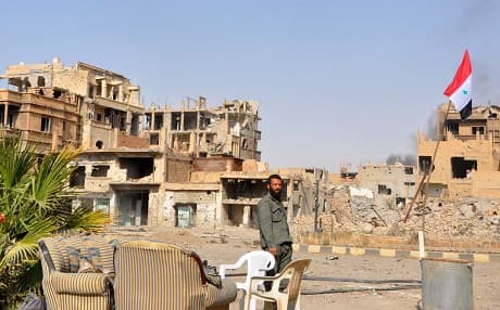 A Syrian pro-government forces member patrols in the eastern city of Deir Ezzor on November 4, 2017 CREDIT: AFP