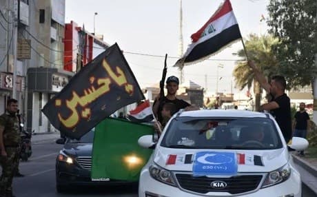 People celebrate after Iraqi forces and Shiite militias took control of the diverse city of Kirkuk on October 16. Photo: Marwan Ibrahim/AFP
