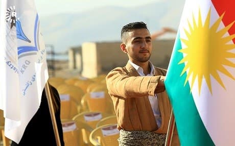 Kurdish student raises the flag of Kurdistan in a graduation ceremony in November 2017 in Sulaimnai, Kurdistan Region. File photo: Rudaw/Sartip Othman