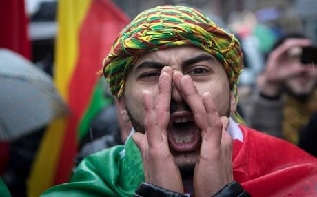 A member of the Kurdish community in Germany protests against the the Turkish offensive launched against the Kurdish-controlled Afrin canton in western Syria. Photo: AFP / dpa / Boris Roessler