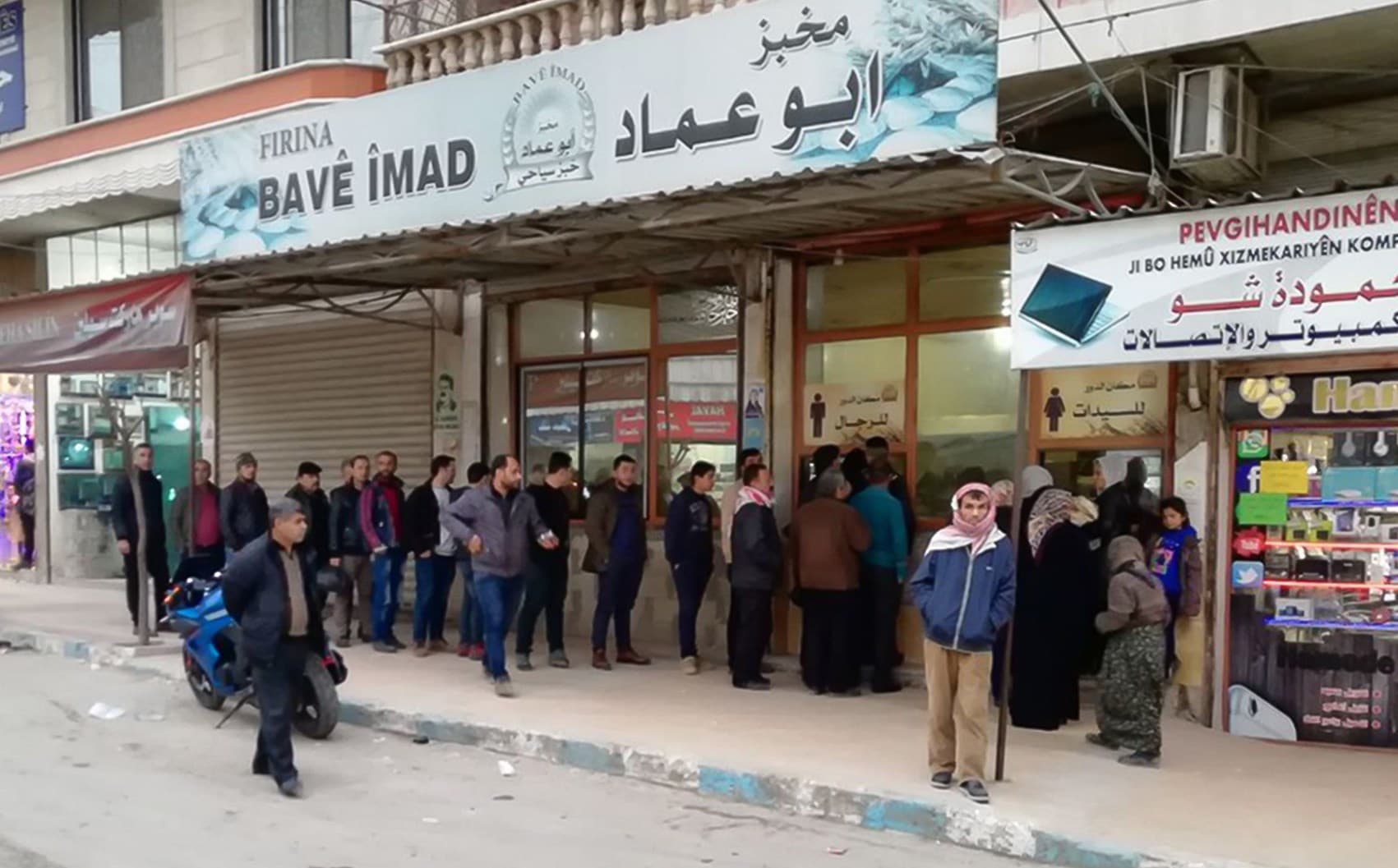 People queue at a bakery in Afrin on Monday. Photo: Diyar Mostefa/AFP