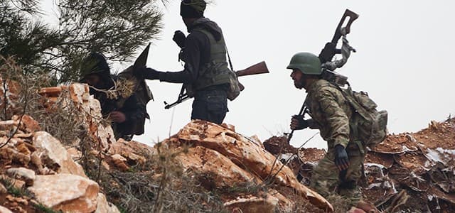Turkish soldiers and Turkish-backed Syrian rebel fighters are seen around the area of Mount Bersaya, north of Azaz near the border with Turkey on January 22, 2018. Photo: Nazeer al-Khatib | AFP