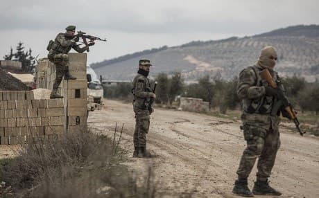 Turkey-backed Free Syrian Army fighters secure an area where Turkish army’s Operation Olive Branch continue in Azaz, northwestern Syria, Wednesday, Jan. 24, 2018. Photo (DHA-Depo Photos via AP)