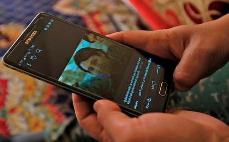 A picture taken on February 2, 2018 in the town of Afrin shows Amed Kendal, a military commander of the YPJ, displaying a picture of late 23-year-old Barin Kobani. Photo: Delil Souleiman | AFP