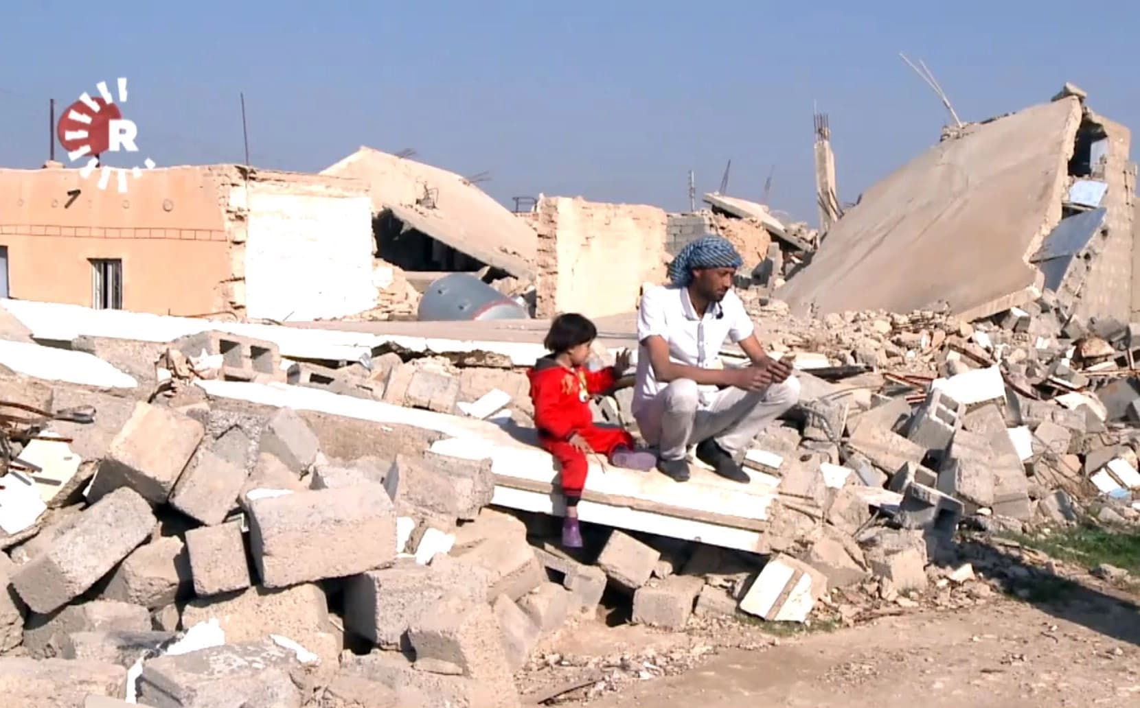 Residents of Shingal sit in the ruins that remain more than two years after the town was liberated from ISIS. Photo: Rudaw video