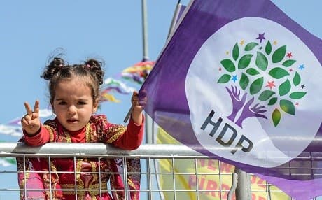 A young girl waves a HDP flag at Newroz celebrations in Diyarbakir. Photo: Ilyas Akengin/AFP