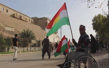 A Kurdish man raised the Kurdistan flag in the disputed city of Kirkuk on March 20, 2018 to celebrate Newroz, the Kurdish new year. File photo: Rudaw TV