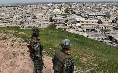 Syrian regime forces look out over Tal Rifaat this week. Photo: George Ourfalian/AFP