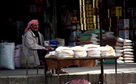 A man sells bread at the open air market in Manbij on March 28, 2018. Photo: Delil Souleiman | AFP