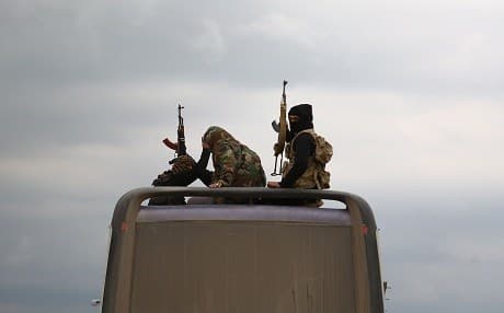 Buses carrying Jaysh al-Islam fighters and their families from their former rebel bastion of Douma, arrive at the Abu al-Zindeen checkpoint controlled by Turkish-backed rebel fighters near the northern Syrian town of al-Bab, on April 10, 2018. Photo: Nazeer al-Khatib | AFP