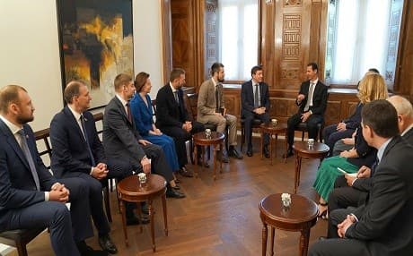 A handout picture on April 15, 2018 shows Syrian President Bashar al-Assad (center-right) receiving a delegation from the Russia's ruling United Russia political party in Damascus. Photo: SANA via AFP
