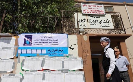 Iraqi man walks outside a poll station in the northern multi-ethnic city of Kirkuk on May 12, 2018. Photo: Marwan Ibrahim / AFP