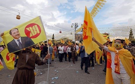 People wave flags as they attend an electoral rally for the Kurdistan Democratic Party in Erbil, Kurdistan Region, on May 10, 2018. Photo: Safin Hamed | AFP
