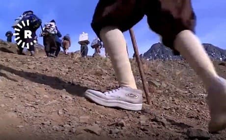 Kolbars are cross-border porters carrying goods on their backs across the Kurdistan Region-Iran border. File photo: Rudaw