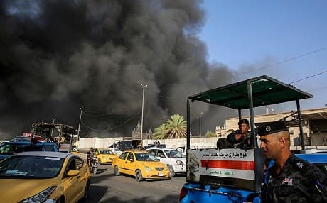 Smoke billows from a fire at a warehouse of the Iraqi election commission in Baghdad on Sunday. Photo: Sabah Arar/AFP