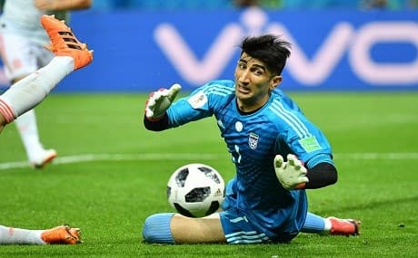 Iran's goalkeeper Alireza Beiranvand dives to save the ball during the Russia 2018 World Cup Group B football match between Iran and Spain at the Kazan Arena in Kazan on June 20, 2018. Photo: Saeed Khan / AFP