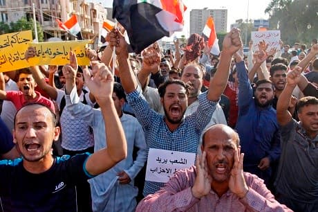 Iraqis shout slogans during a protest in Najaf on Friday. Photo: Haidar Hamdani/AFP