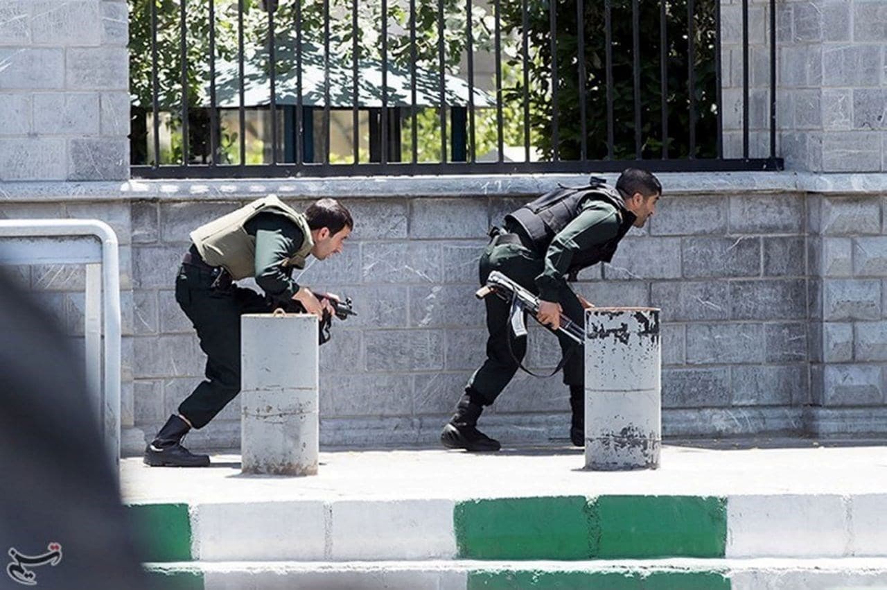 Members of Iranian forces take cover during an attack on the Iranian parliament in Tehran on June 7, 2017. Photo: Tasnim