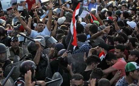 Protesters in Baghdad’s Tahrir Square clash with security forces on Friday. Photo: Ahmad al-Rubaye/AFP