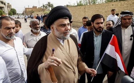 Iraqi Shiite cleric and leader Moqtada al-Sadr shows his ink-stained index fingerholy city of Najaf on May 12, 2018. Photo: AFP