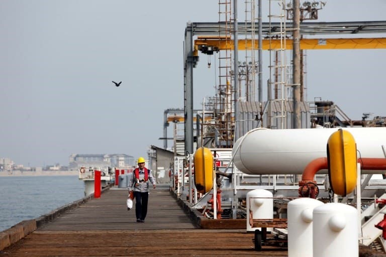 An Iranian labourer walks the platform of the oil facility in the Khark Island, on the shore of the Gulf, on March 12, 2017. Photo: Atta Kenare | AFP