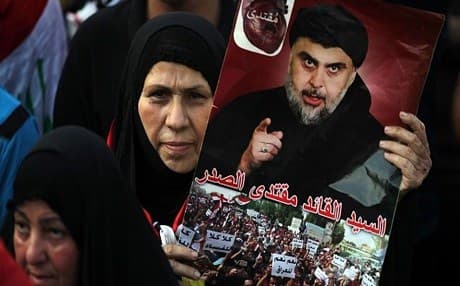 An Iraqi woman holds a poster of firebrand Shiite cleric Muqtada al-Sadr in May 2018. Photo: Ahmed al-Rubaye | AFP