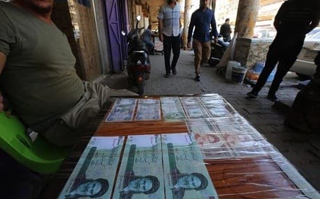 An Iraqi peddler displays Iranian currency for sale in the capital Baghdad, on August 9, 2018. Photo: Ahmad al-Rubaye | AFP