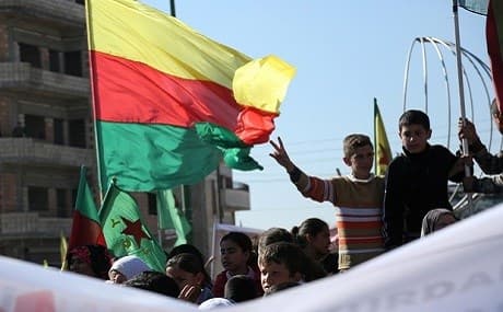 Syrian Kurds fly the flags of Rojava and the YPG. File photo: AFP