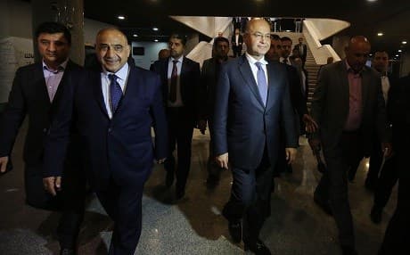 Iraqi Prime Minister-designate Adel Abdul Mahdi (2nd L) walks out of the parliament with Iraqi President Barham Saleh (R) on October 2, 2018. Photo: Ahmad al-Rubaye/AFP