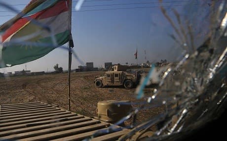 Flag of the Kurdistan Region flies over a battlefield during the ISIS war. Photo: Rudaw