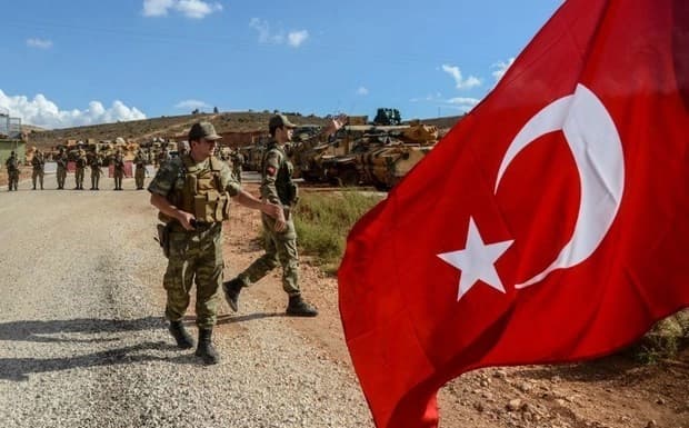 Turkish soldiers picture near the border with Syria’s Idlib. File photo: Ilyas Akengin/AFP