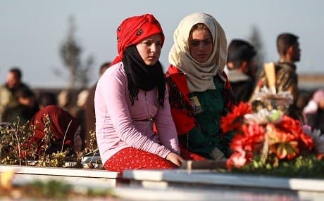 Civilians from the village of Tal Tamr attend the funeral of an Arab fighter of the Syrian Democratic Forces (SDF) in the town in the countryside of Syria's northeastern Hasakeh province on December 21, 2018, who was killed while fighting against ISIS in Hajin. Photo: Delil Souleiman/AFP