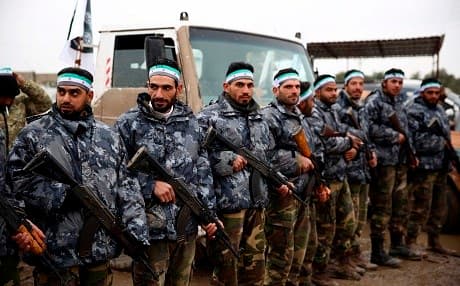 Turkish-backed Syrian fighters are pictured at their barracks in the rebel-held border town of Jarablus on December 25, 2018, as they prepare to move towards Manbij. Photo: Nazeer al-Khatib/AFP