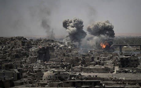 In this July 11, 2017 file photo, airstrikes target Islamic State group positions on the edge of the Old City, in Mosul, Iraq. AP